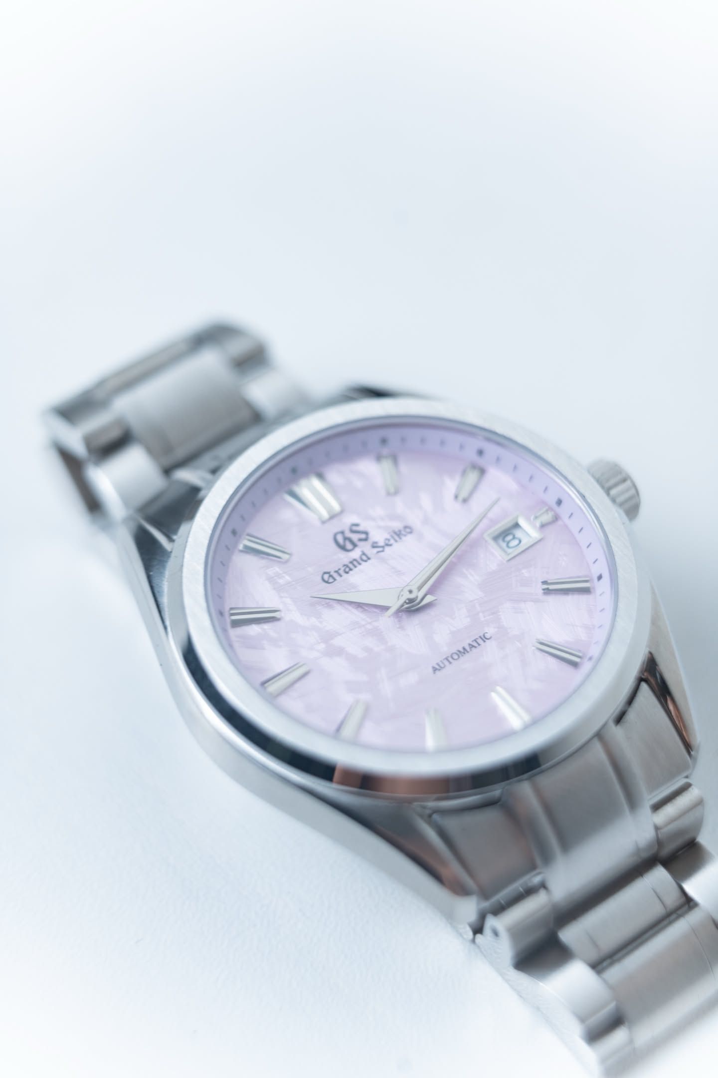 Cherry at an angle, light running across the polished bezel and brushed case.